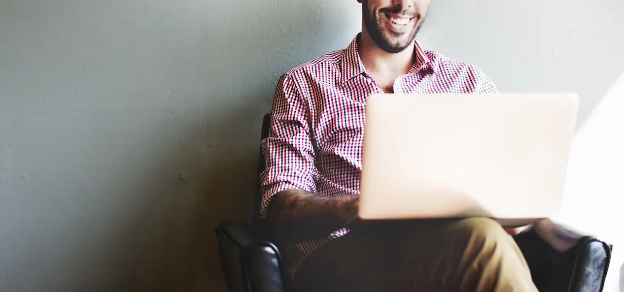 A small business owner using their computer to earn digital service revenue