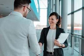 5 ways to sell professional services with campaign strategy. An image of two people shaking hands to seal the deal.