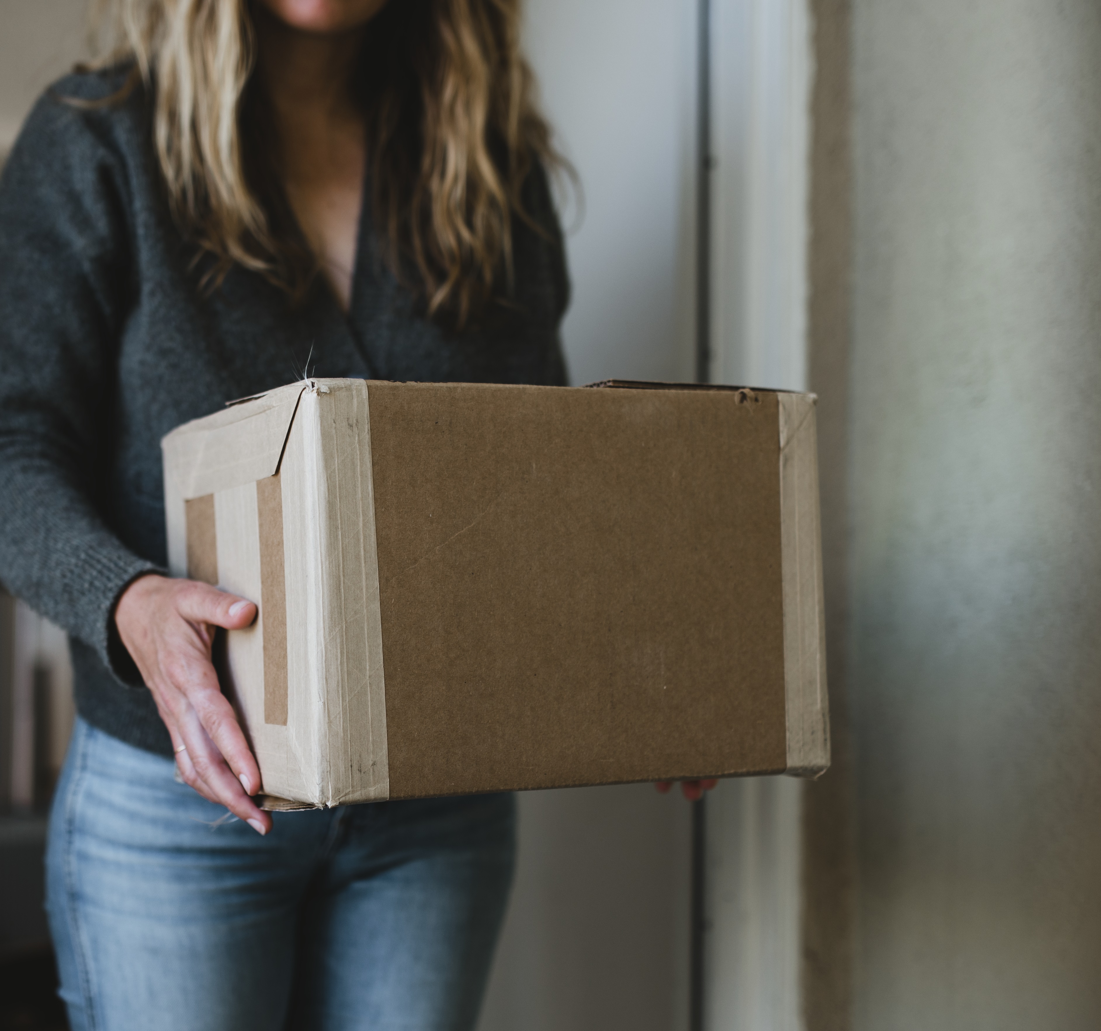 A woman carrying a box.
