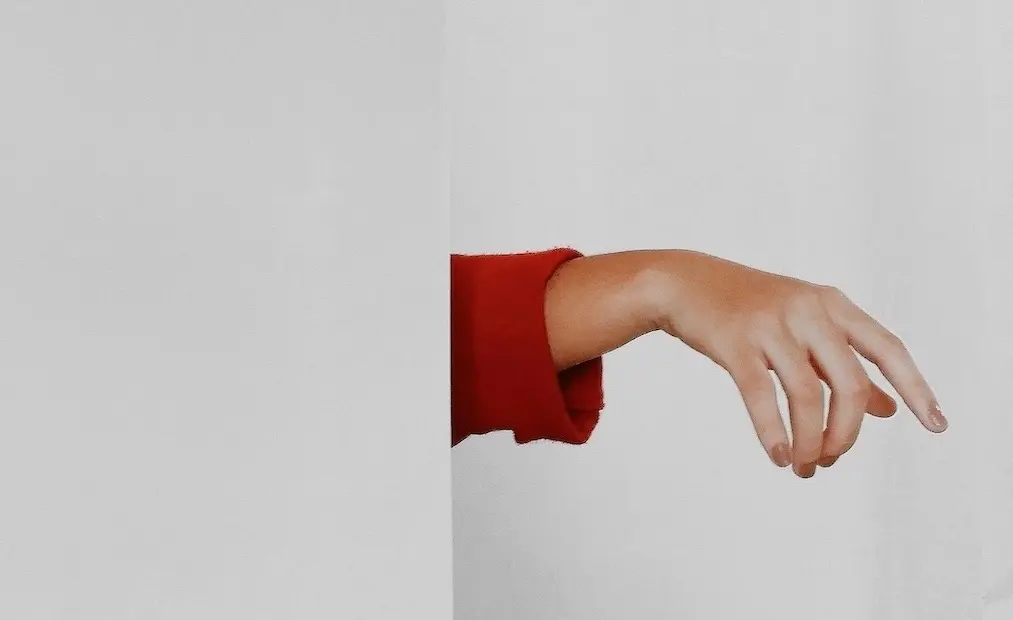 A hand of a business owner reaching out for freedom